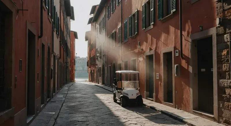 Golf cart tour Florence private group riding through the historic Oltrarno district past Ponte Vecchio on the Arno River